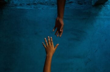 a pair of hands on a blue surface