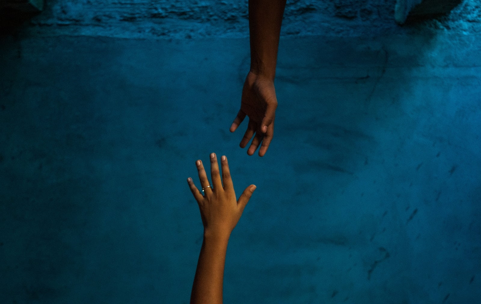 a pair of hands on a blue surface