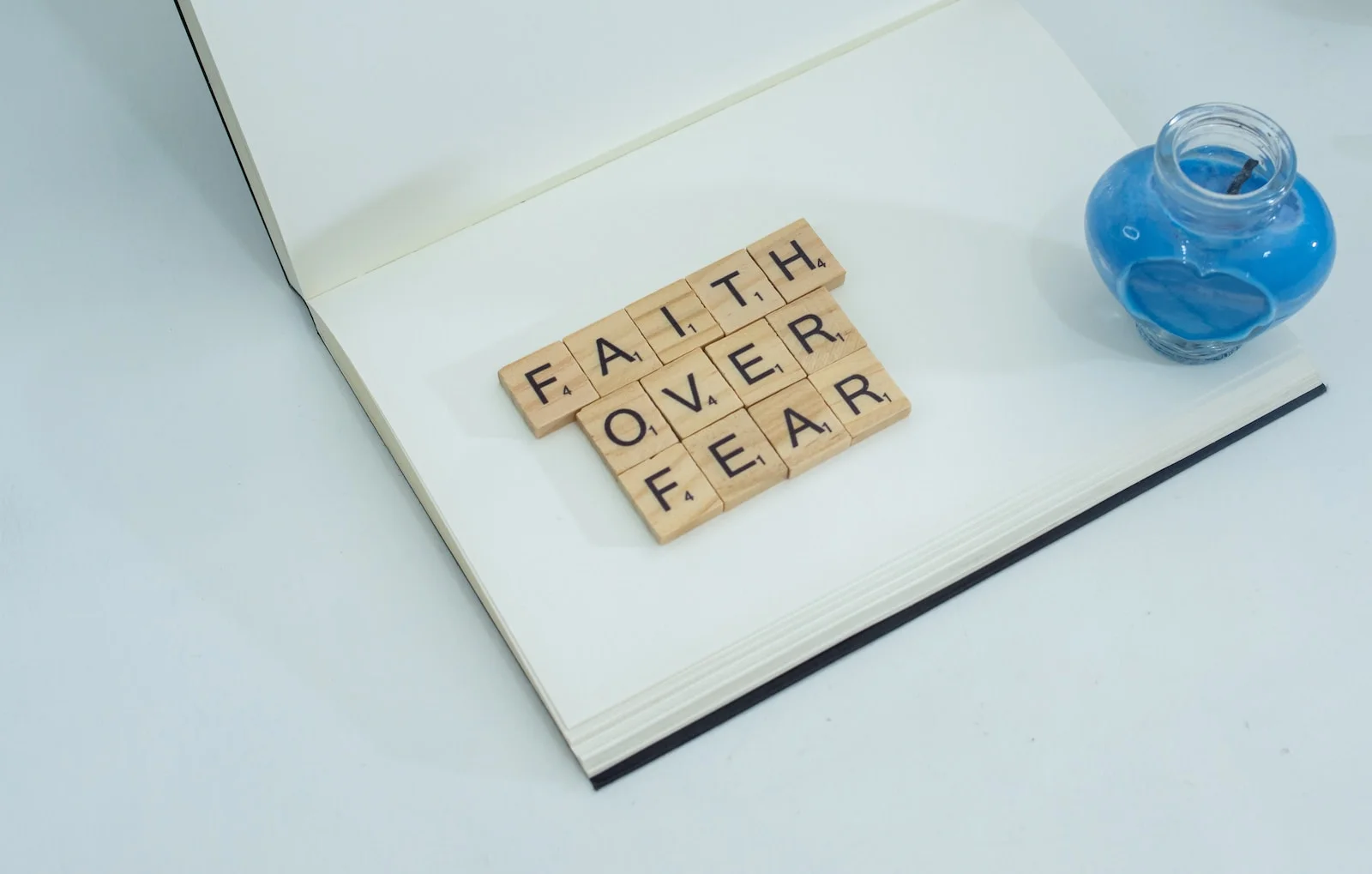 a scrabble of letters spelling faith over fear