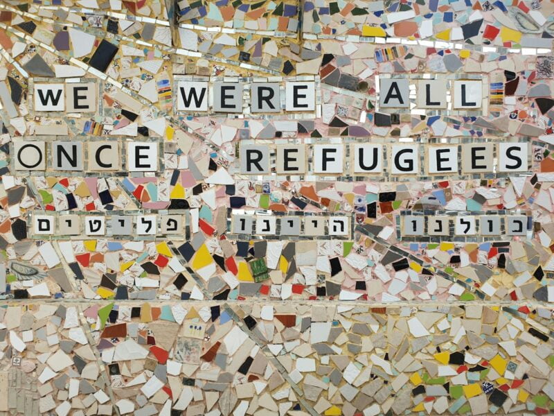 we were all once refugees text on multicolored ceramic tile