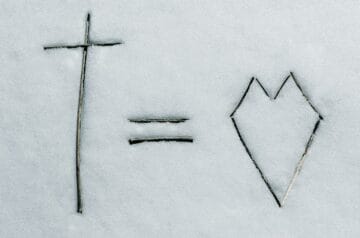 a cross and a line drawn in the snow